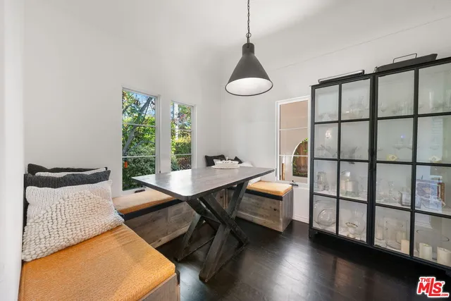 a kitchen with kitchen island granite countertop lots of counter top space a sink stainless steel appliances and windows