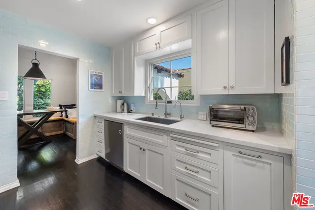 a large kitchen with stainless steel appliances lots of counter space and a sink