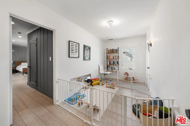 a spacious bedroom with a large bed and wooden floor