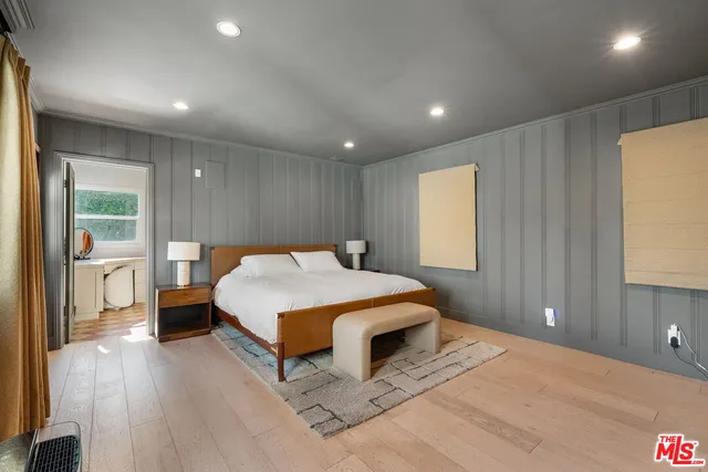 a large bedroom with a large bed and a large window