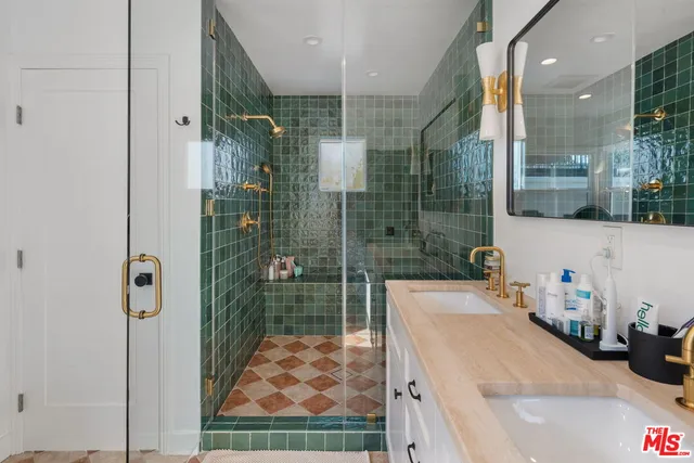 a bathroom with a granite countertop sink mirror and shower