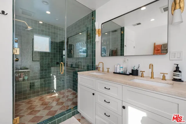 a bathroom with a granite countertop sink mirror vanity and toilet