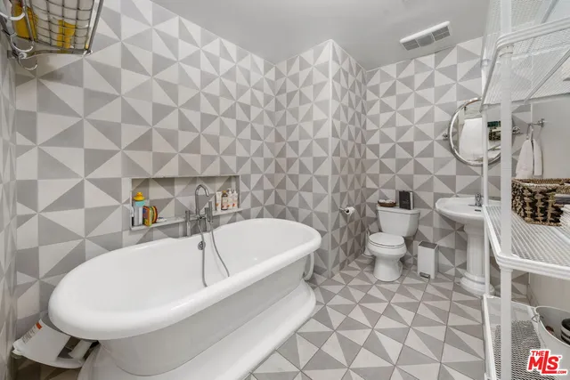 a living room with furniture and a painting on the wall