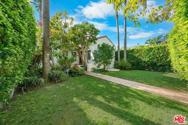 a view of a garden with a building in the background