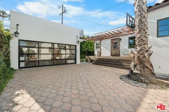 a view of a house with a yard and a garden