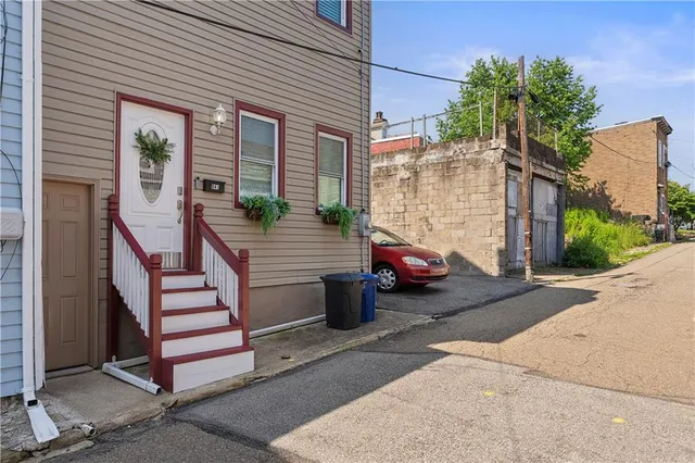 a view of a wooden chair and fire pit in the patio
