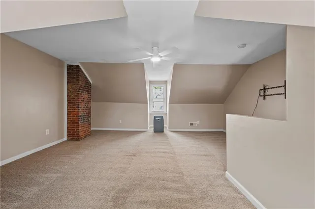 an empty room with a windows and ceiling fan