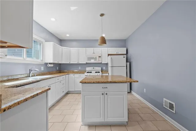 a kitchen with a sink window and cabinets