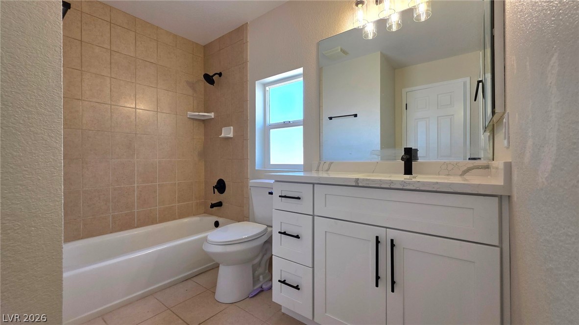 2155 Athol Way Laughlin, NV 89029 - Photo 7 of 19 Modern bathroom featuring sleek white cabinetry, a generous vanity, and tiled shower/tub combo for daily rejuvenation.