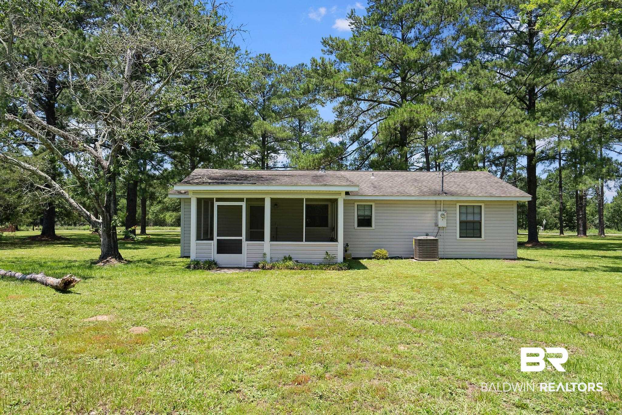 20540 Lacey Road Silverhill, AL 36576 - Photo 23 of 40 Rear exterior featuring light-colored siding and a screened porch