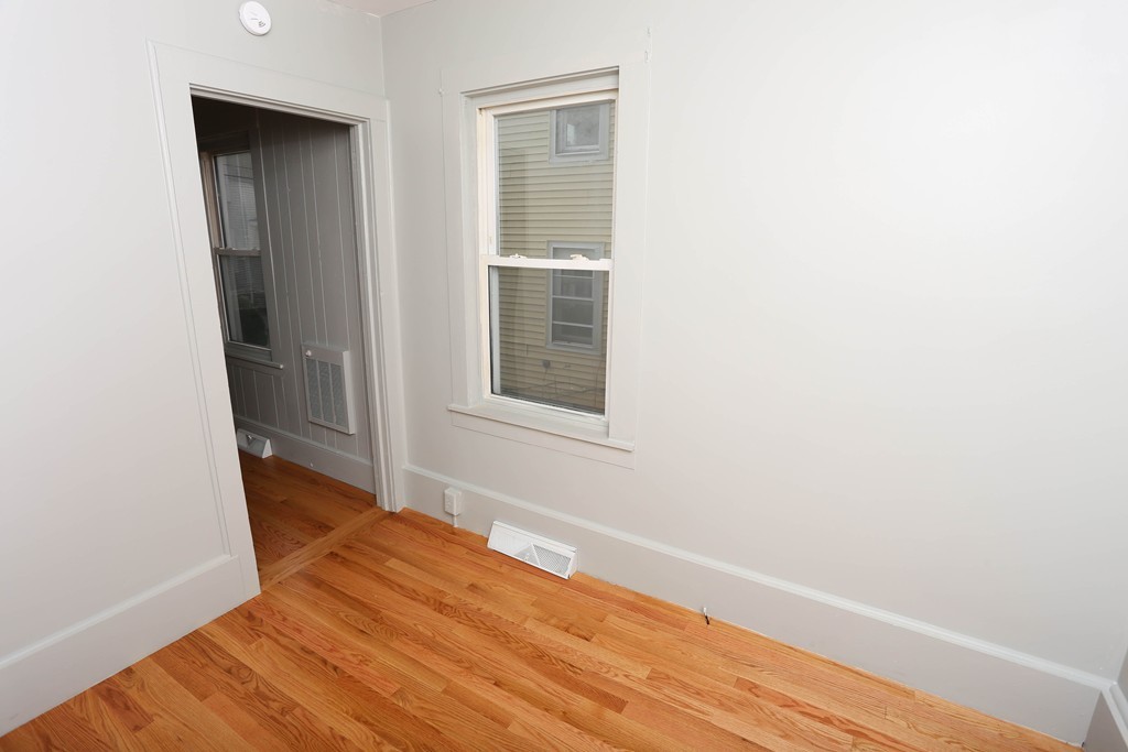 22 Vigeant Street Ware, MA 01082 - Photo 11 of 16 an empty room with wooden floor and windows