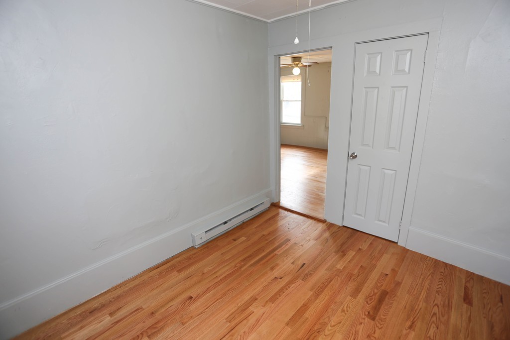 22 Vigeant Street Ware, MA 01082 - Photo 14 of 16 a view of an empty room with wooden floor and a window