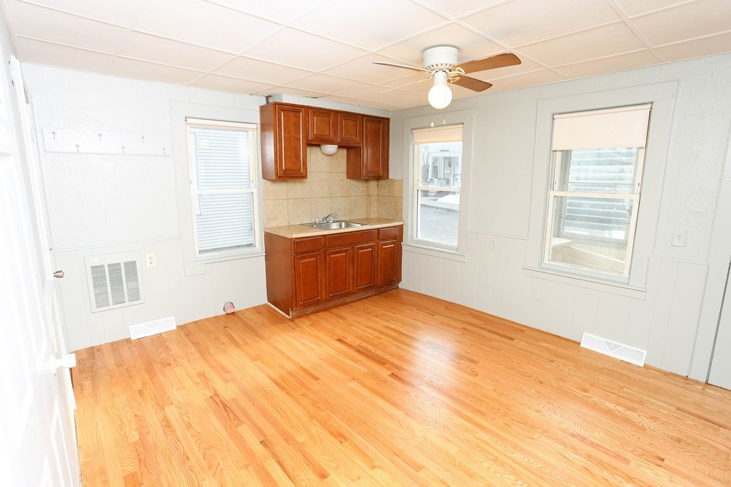 22 Vigeant Street Ware, MA 01082 - Photo 6 of 16 a bedroom with a large bed a chandelier and dresser