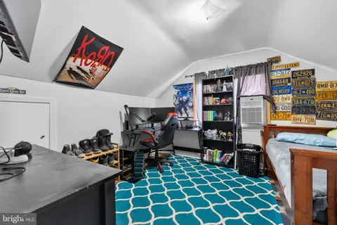 a room with furniture a rug and a book shelf