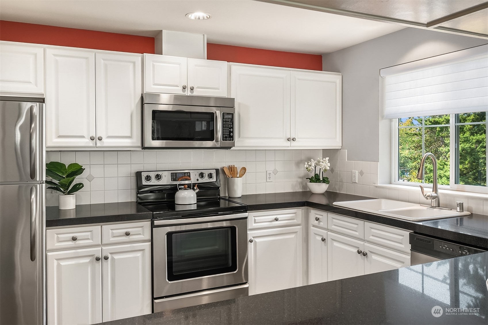 7207 210th Street Southwest, Unit 201 Edmonds, WA 98026 - Photo 8 of 19 a kitchen with granite countertop white cabinets and white appliances