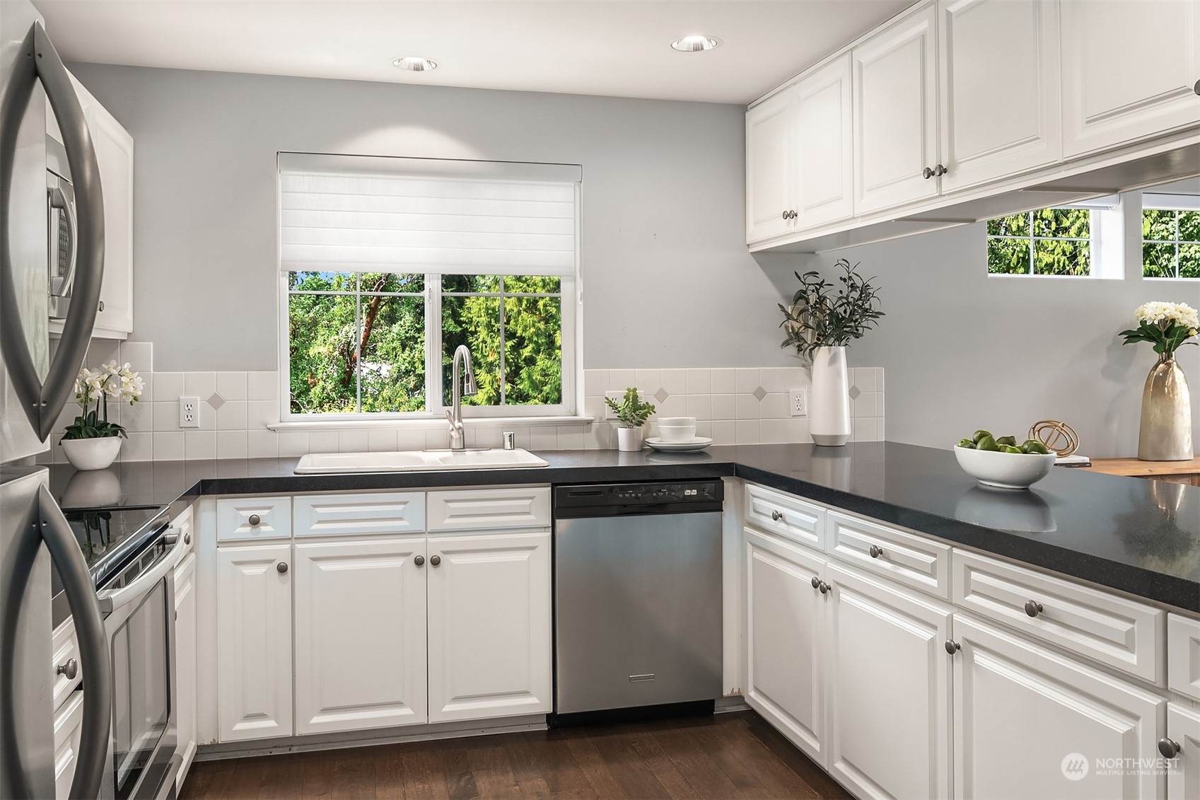 7207 210th Street Southwest, Unit 201 Edmonds, WA 98026 - Photo 9 of 19 a kitchen with white cabinets and a window