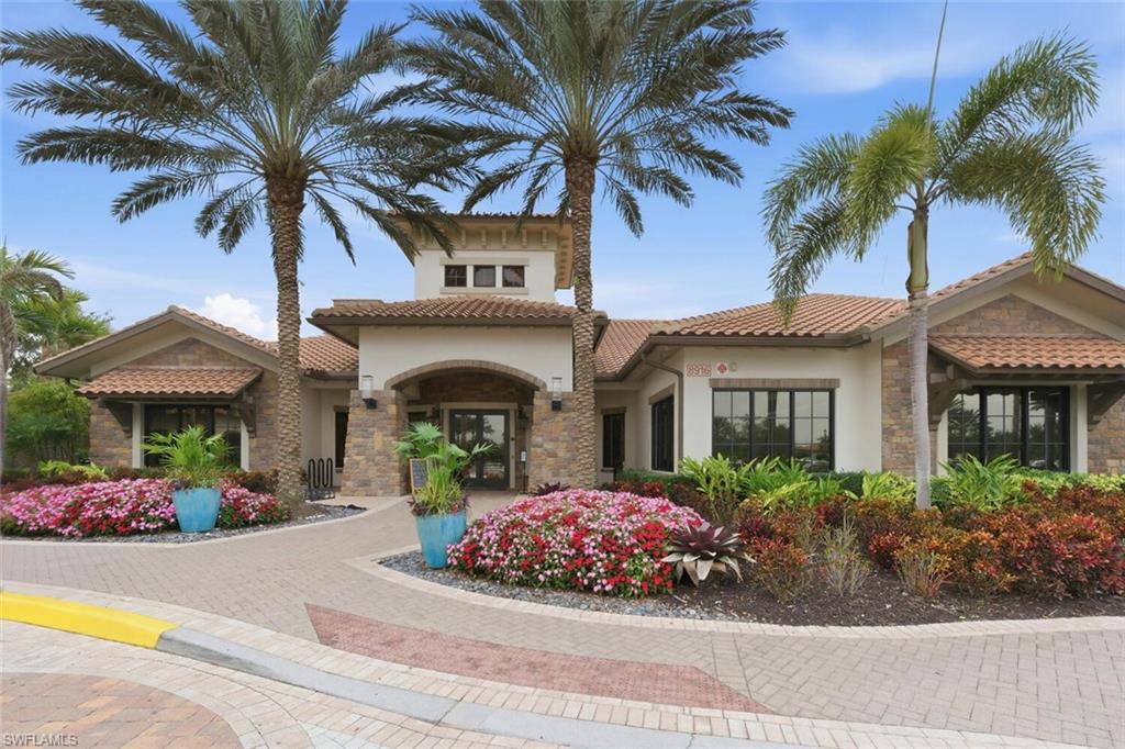 9365 Pocida Court, Unit 202 Naples, FL 34119 - Photo 31 of 40 a front view of a house with garden