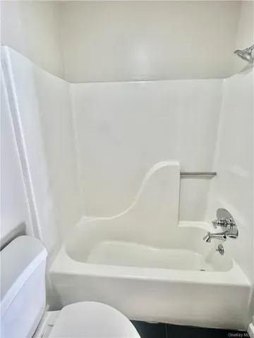 a bathroom with a bathtub and toilet