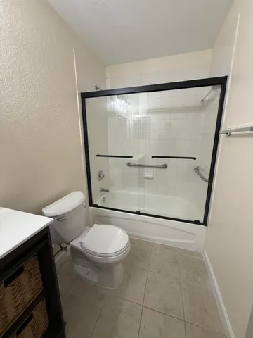 a bathroom with a toilet and a shower