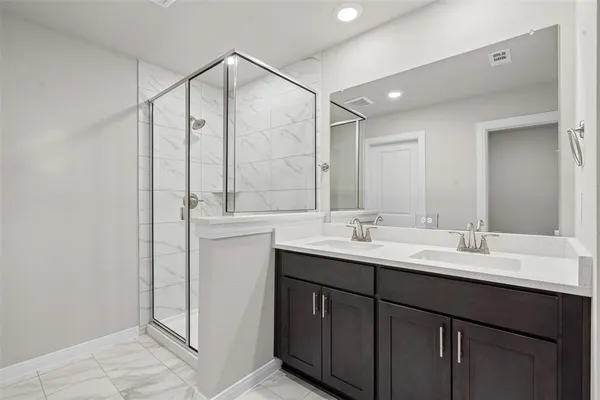 a bathroom with a double vanity sink and mirror