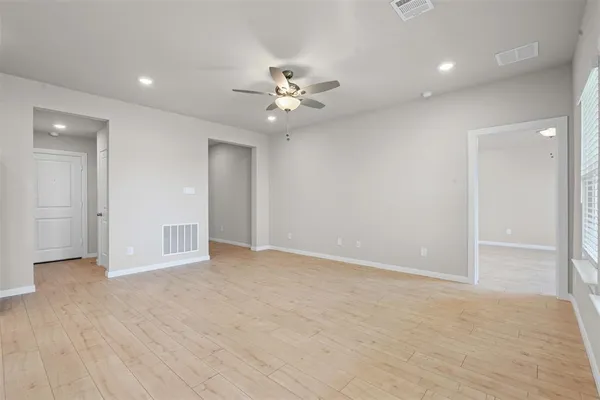 an empty room with fan and a ceiling fan
