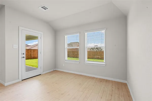 an empty room with a window and a fireplace