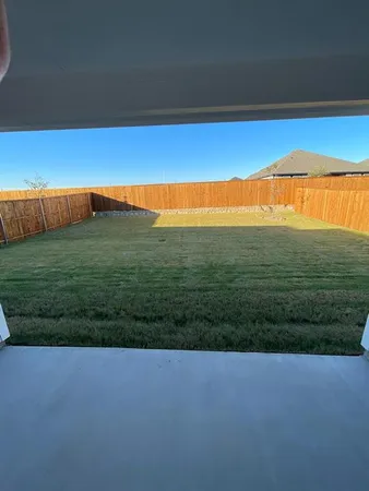 a view of a field with an ocean