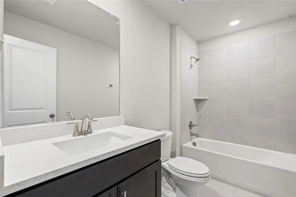 a bathroom with a sink a toilet a mirror and shower