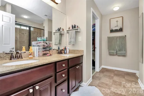 a bathroom with double vanity sinks double vanity and a shower