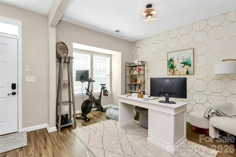 a view of a workspace with furniture and a window