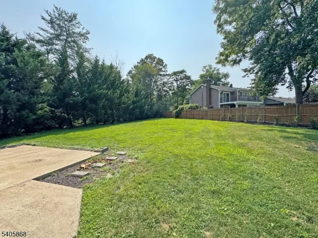 a swimming pool with outdoor seating and yard