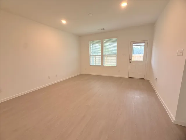 an empty room with a empty space and windows