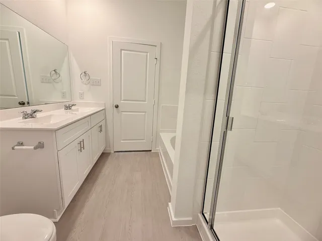 a spacious bathroom with a double vanity sink and a mirror