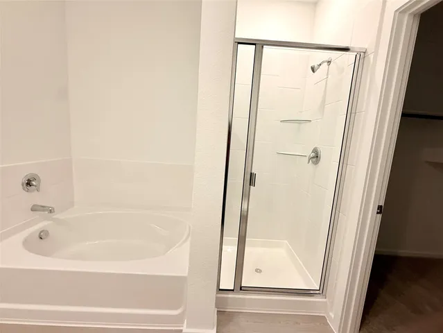a bathroom with bathtub and a shower