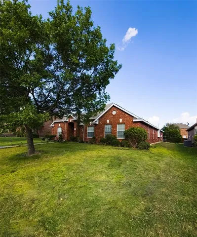 a front view of a house with a big yard