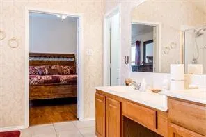 a en suite bathroom with a sink and a mirror