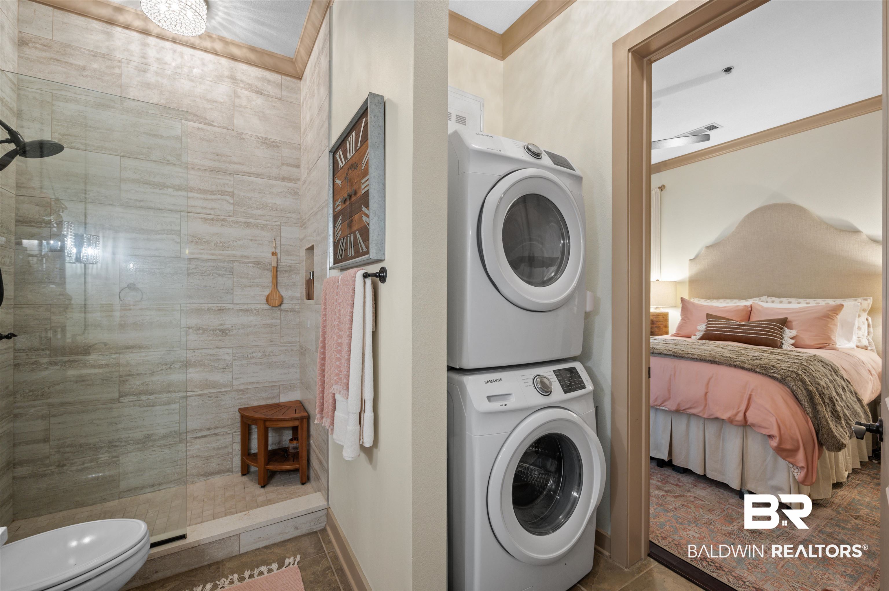 1430 Regency Road, Unit B202 Gulf Shores, AL 36542 - Photo 14 of 33 Clothes washing area featuring stacked washer and dryer, ornamental molding, laundry area, and baseboards