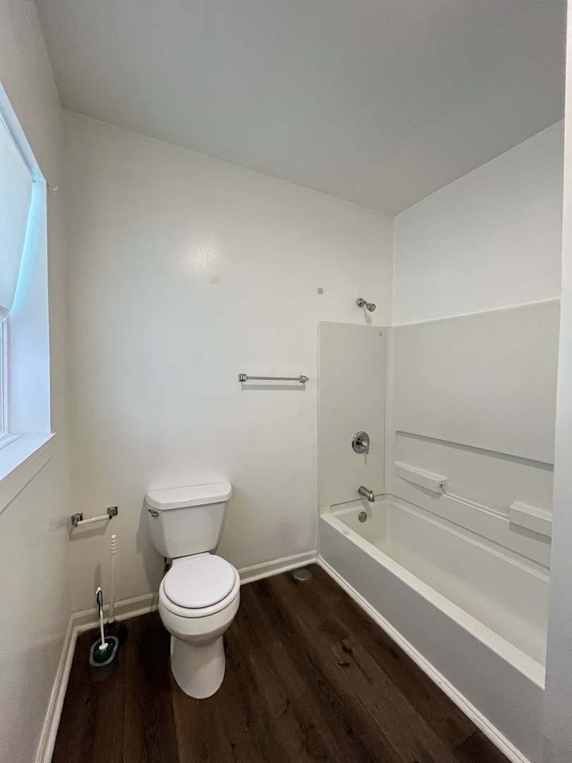 307 Herkimer Street, Unit 2R Joliet, IL 60432 - Photo 11 of 17 a bathroom with a toilet and a shower