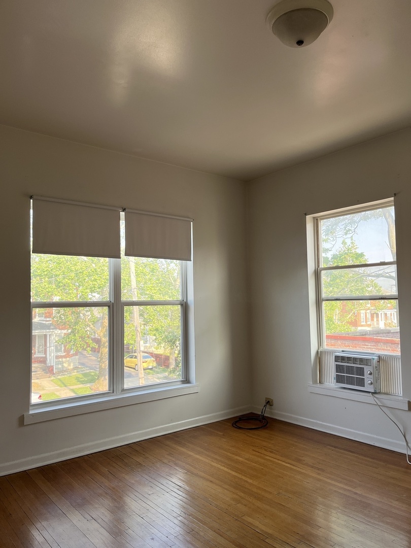 307 Herkimer Street, Unit 2R Joliet, IL 60432 - Photo 14 of 17 an empty room with wooden floor and windows