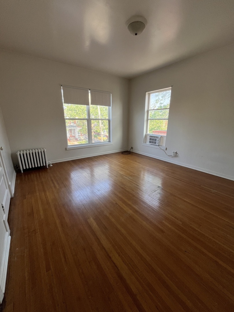307 Herkimer Street, Unit 2R Joliet, IL 60432 - Photo 15 of 17 an empty room with wooden floor and a window