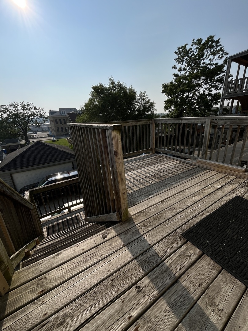 307 Herkimer Street, Unit 2R Joliet, IL 60432 - Photo 17 of 17 a view of a roof deck with wooden floor and fence