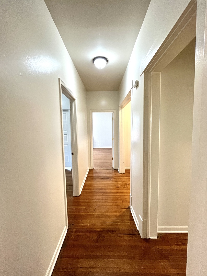 307 Herkimer Street, Unit 2R Joliet, IL 60432 - Photo 7 of 17 a view of a big room with wooden floor and windows