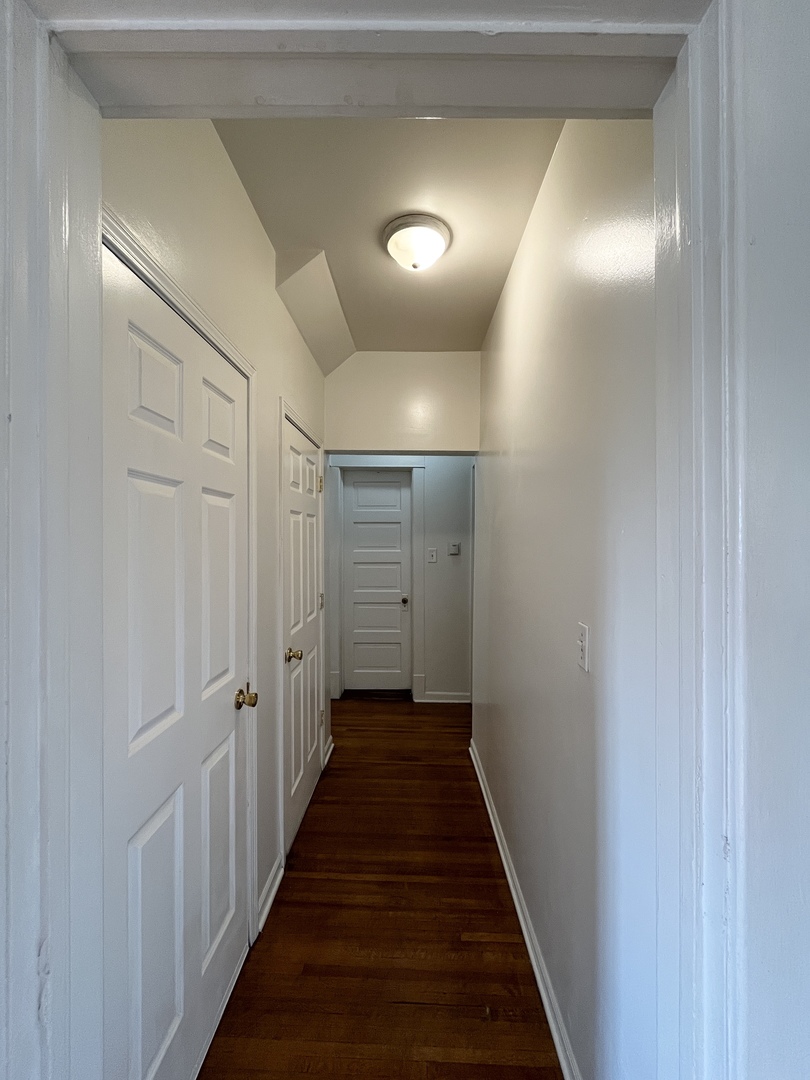 307 Herkimer Street, Unit 2R Joliet, IL 60432 - Photo 8 of 17 a view of a hallway with wooden floor