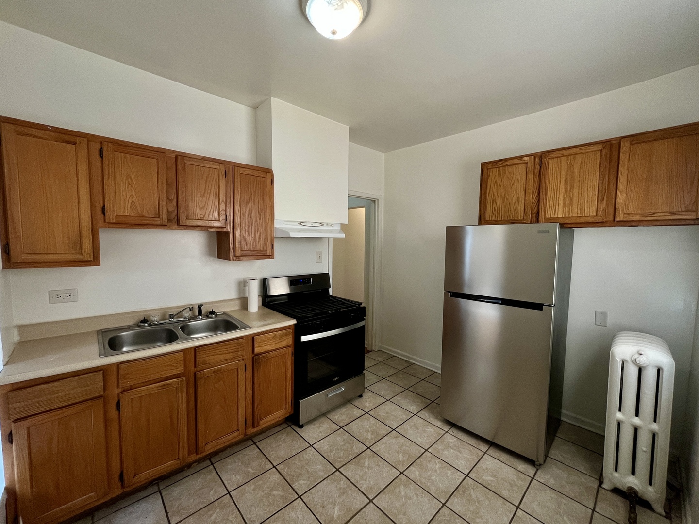 307 Herkimer Street, Unit 2R Joliet, IL 60432 - Photo 9 of 17 a kitchen with stainless steel appliances granite countertop a refrigerator a stove a sink and a cabinets