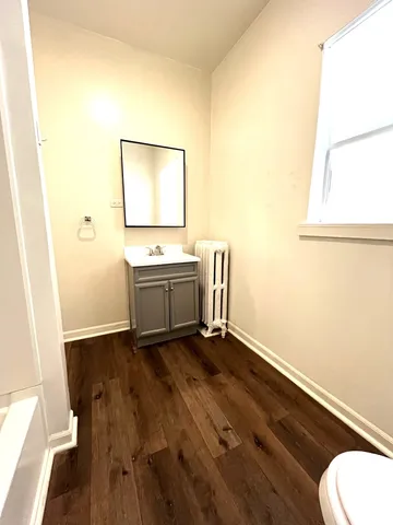 a view of a room with wooden floor and sink