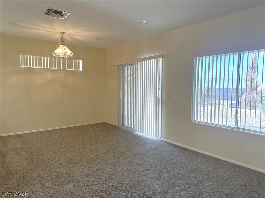 3034 Canal Walk Road Henderson, NV 89052 - Photo 16 of 24 This versatile living space offers natural light and comfortable carpeting, ready for your personal touch.