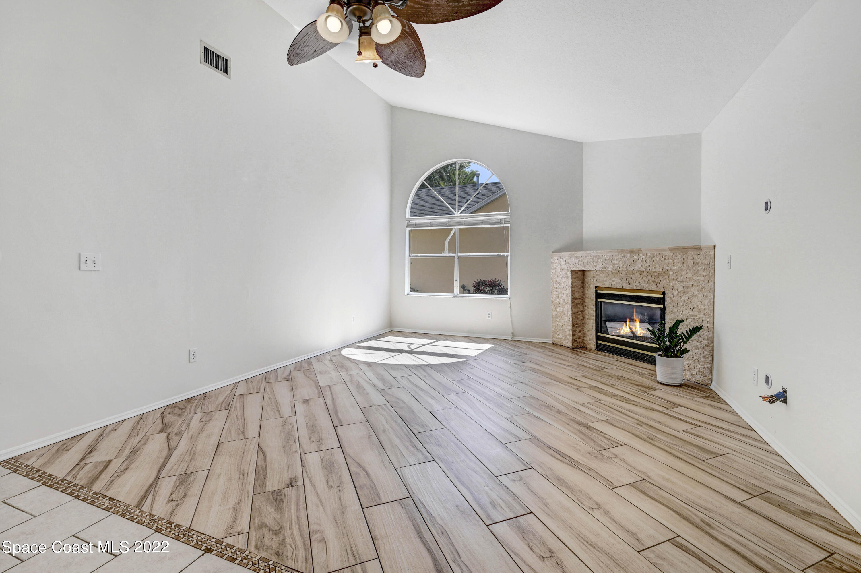 930 Turtle Pond Way Melbourne, FL 32940 - Photo 15 of 56 a view of empty room with wooden floor and fireplace