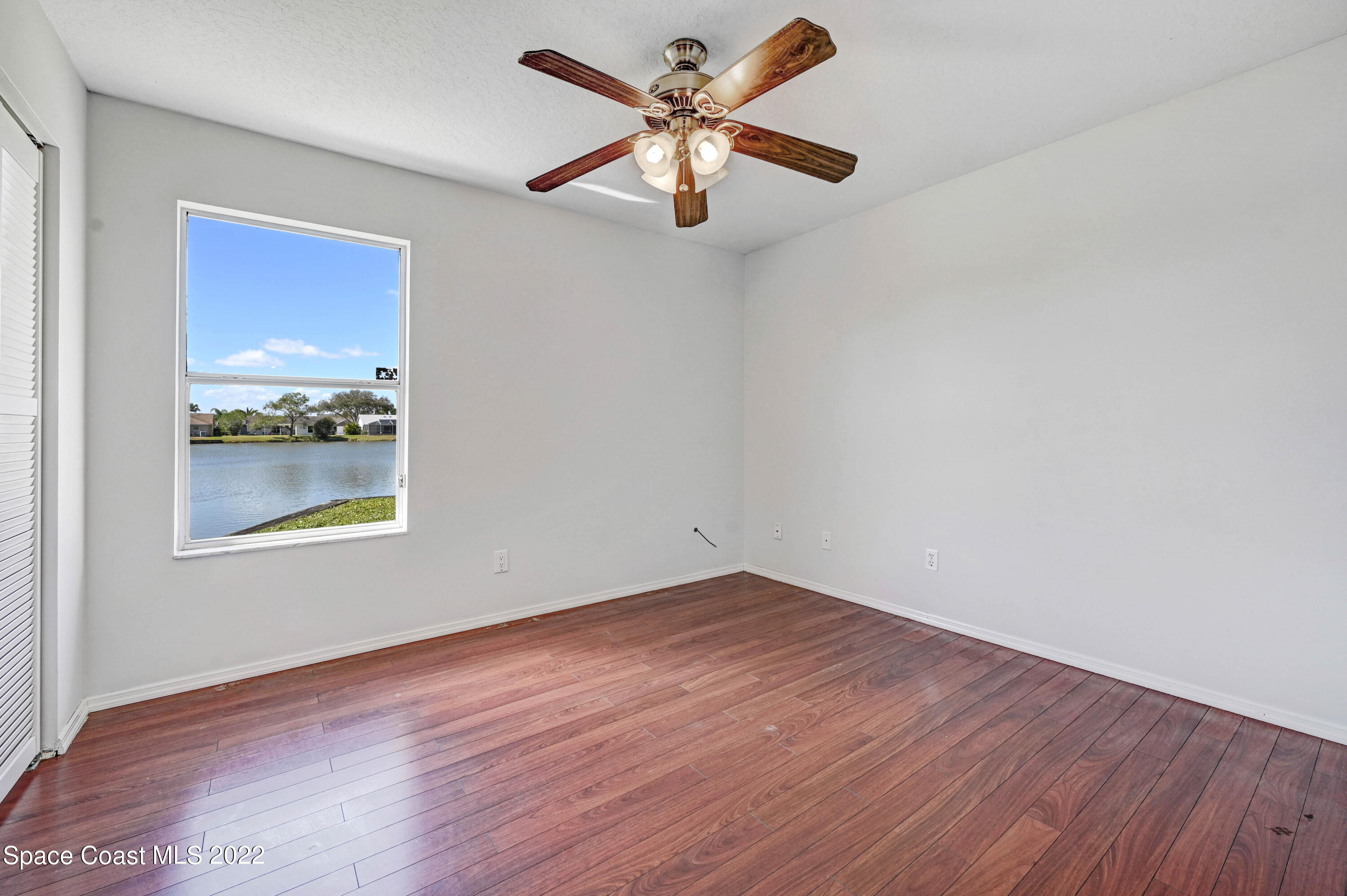 930 Turtle Pond Way Melbourne, FL 32940 - Photo 33 of 56 a view of an empty room with window and wooden floor