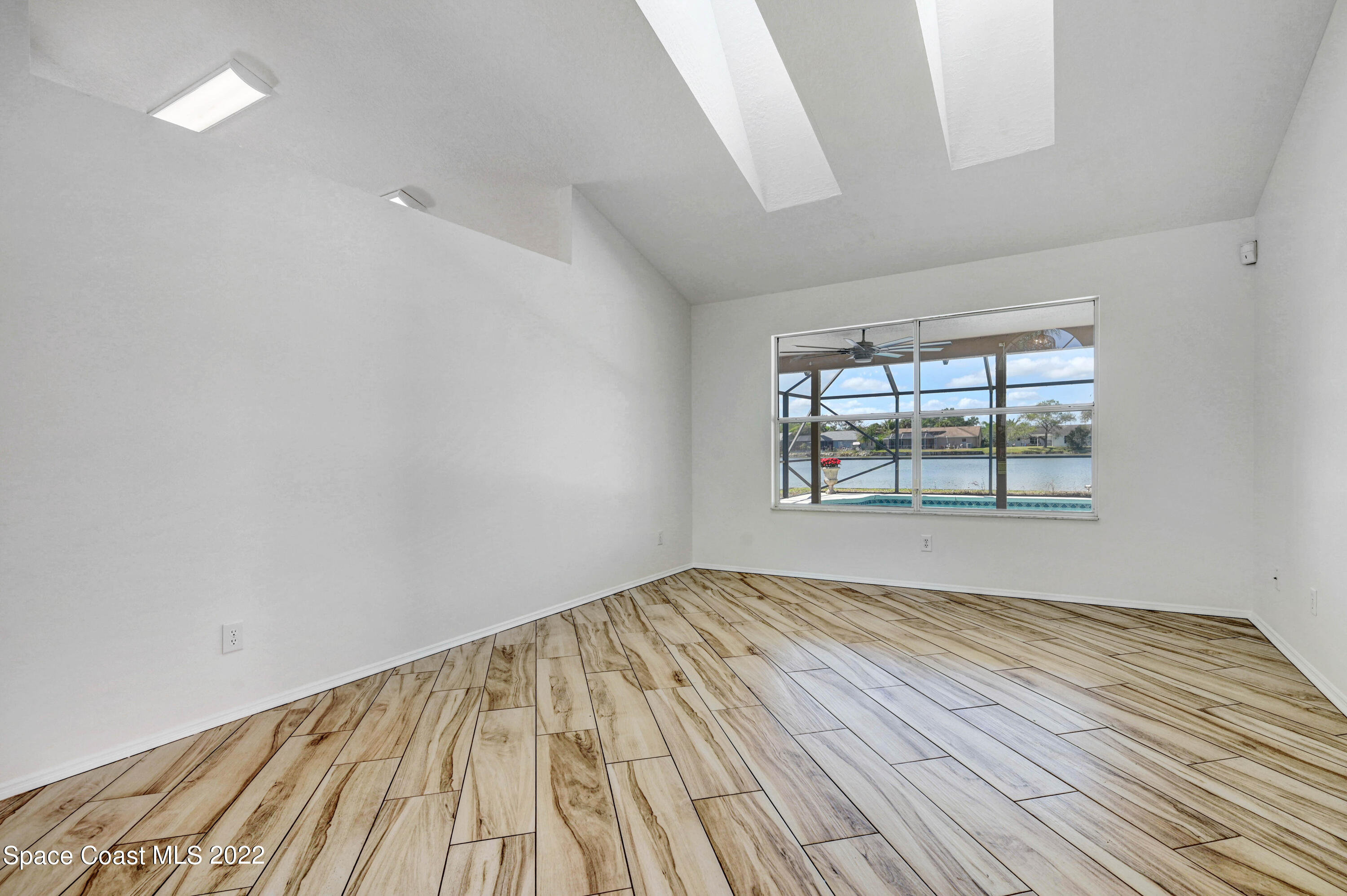 930 Turtle Pond Way Melbourne, FL 32940 - Photo 10 of 56 wooden floor in an empty room with a window