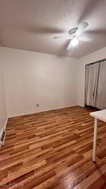 5890 Randy Road Bedford, OH 44146 - Photo 6 of 20 Spare room featuring a textured ceiling, light hardwood floors, and ceiling fan